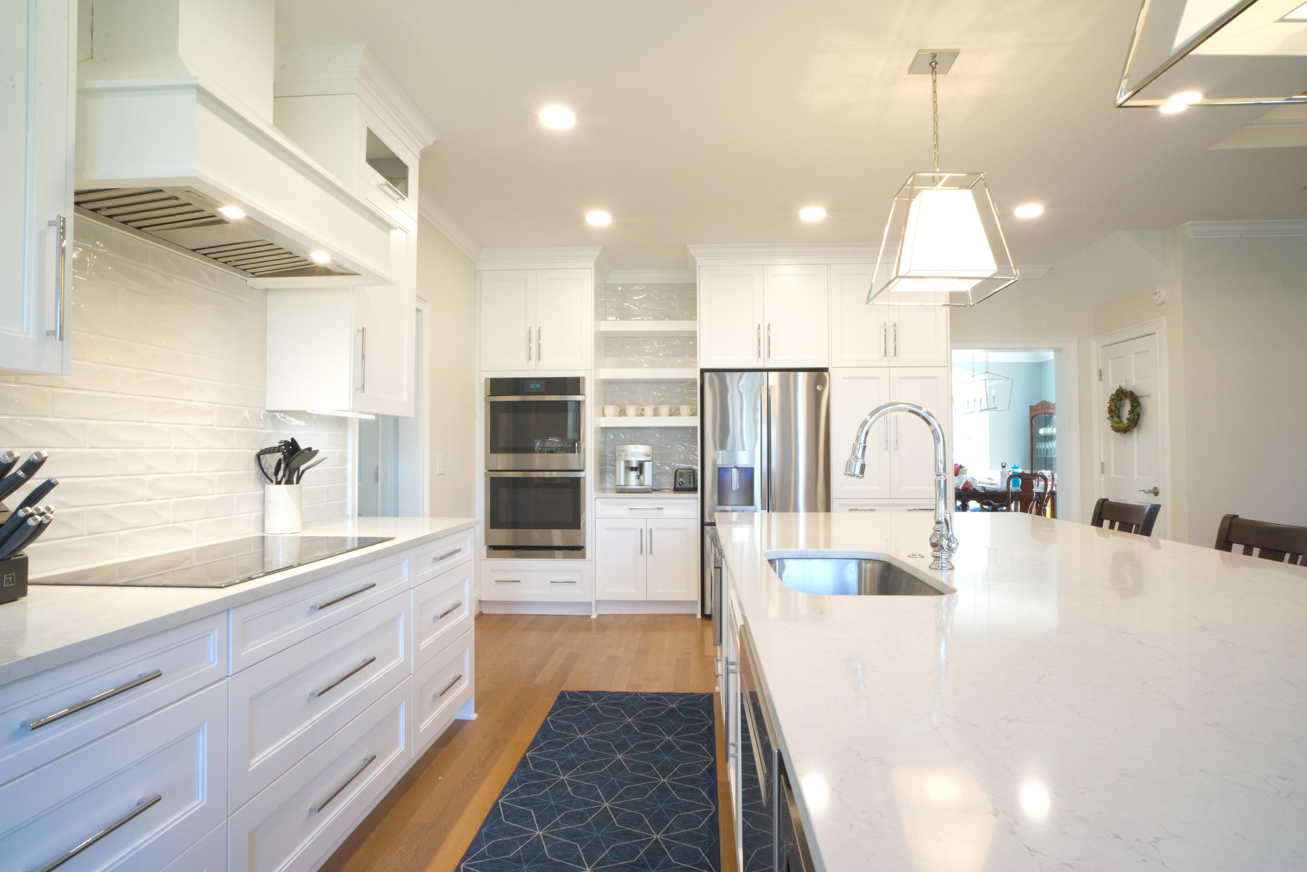 Open floor plan kitchen remodel with classic white and chrome fixture in Morrisville, NC