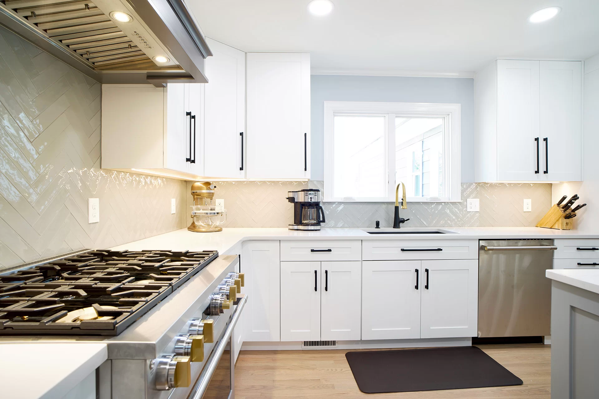 Bright white cabinets and long black cabinet hardware at a Cary NC remodel