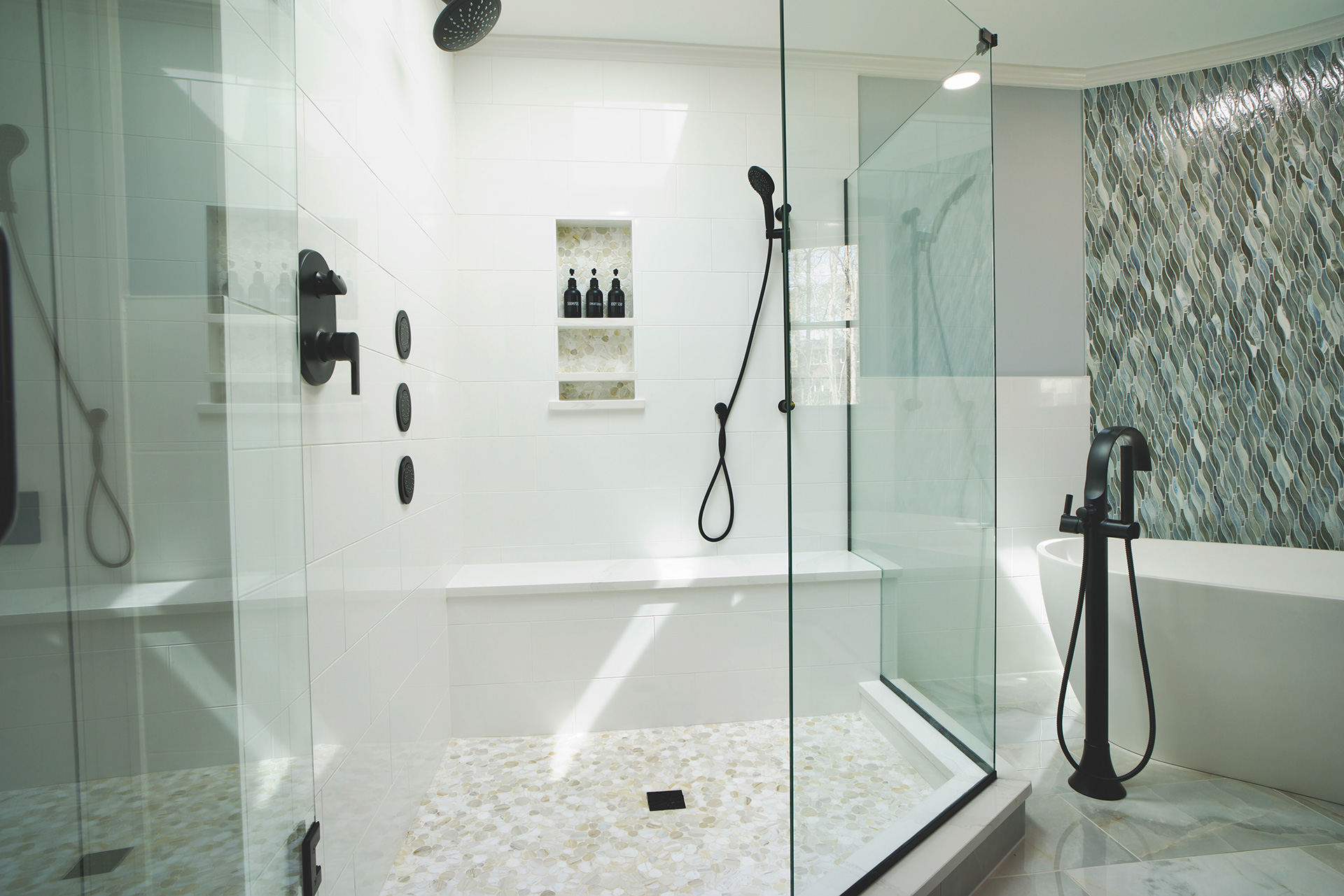 Large corner tub with frameless shower and large seat and skylight