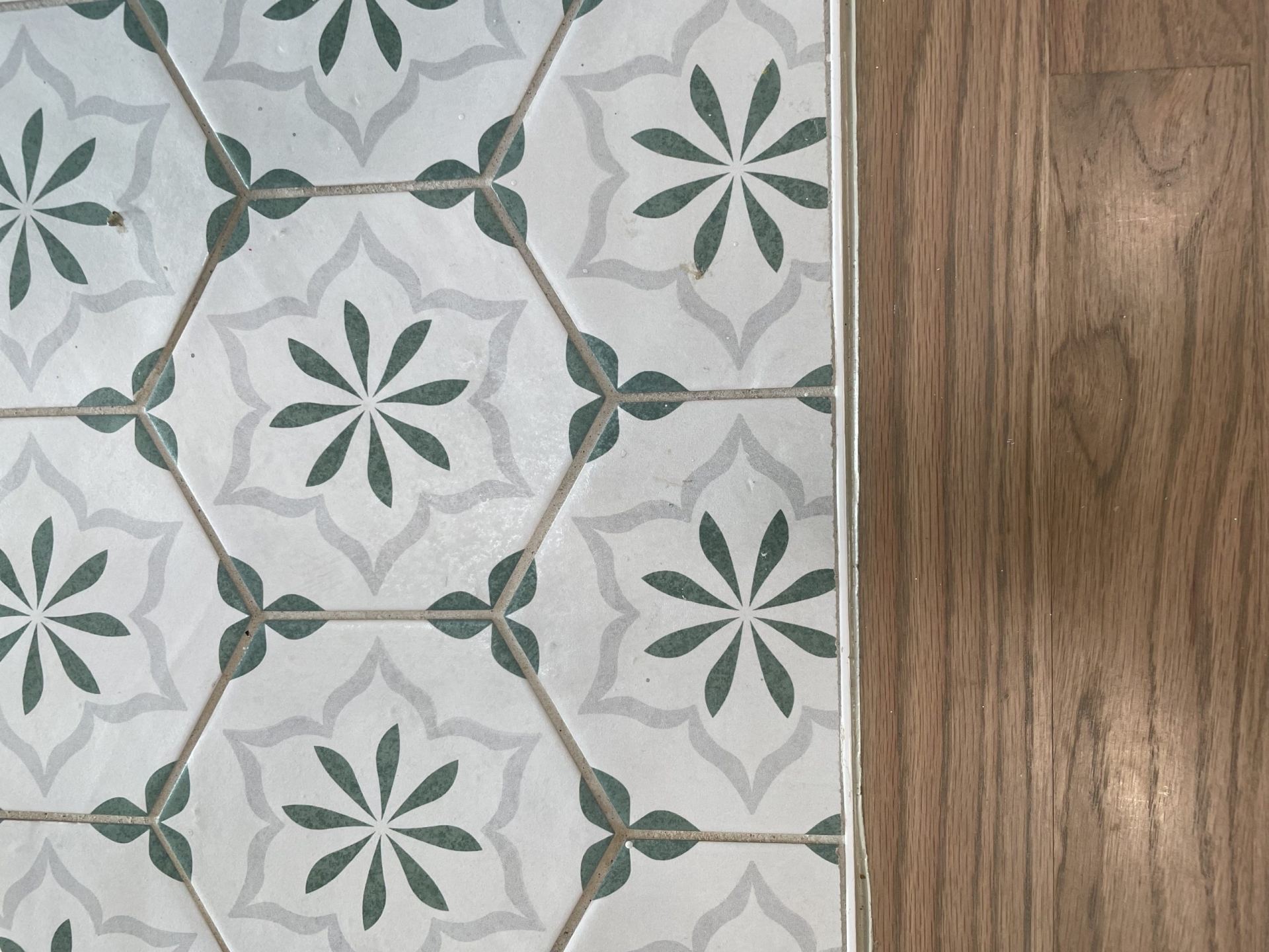 Green and gray painted hexagon floor tile 