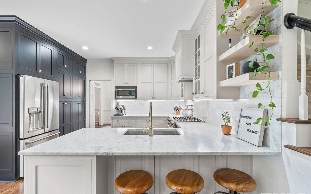 remodeled kitchen with built-in wall cabinets in black with refrigerator built in.