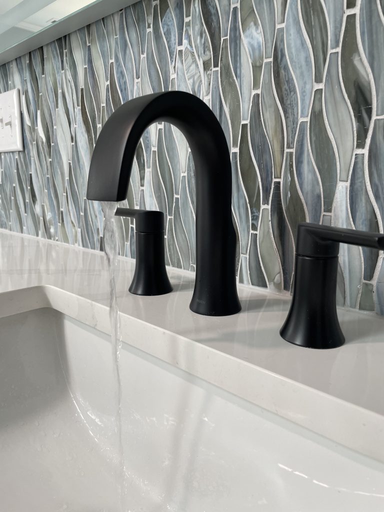 black bathroom faucet with natural blue tile