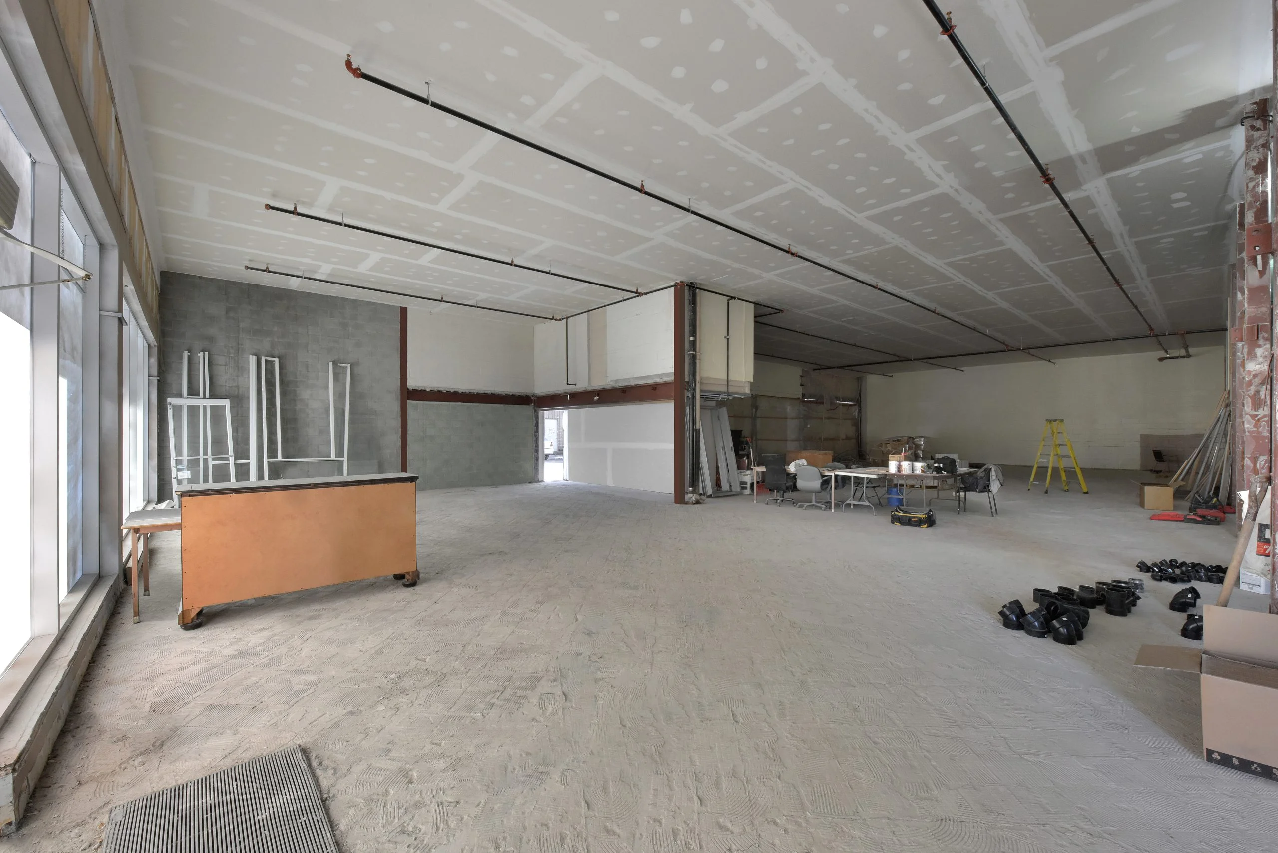 Under construction empty commercial retail space for rent with white walls