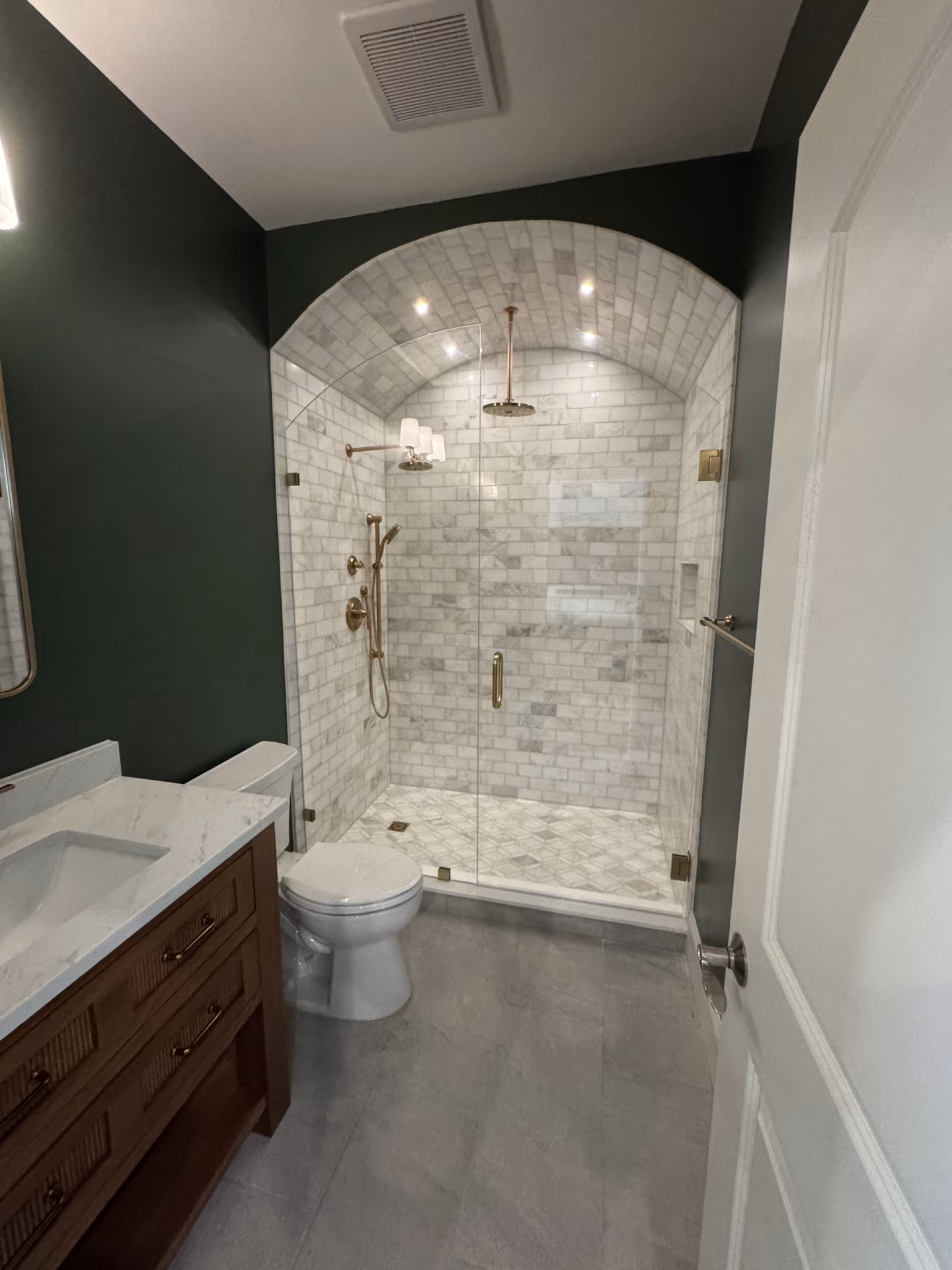 arched walk-in shower with framless glass doors in full shower on third-floor attic finish arched walk-in shower with framless glass doors in full shower on third-floor attic finish